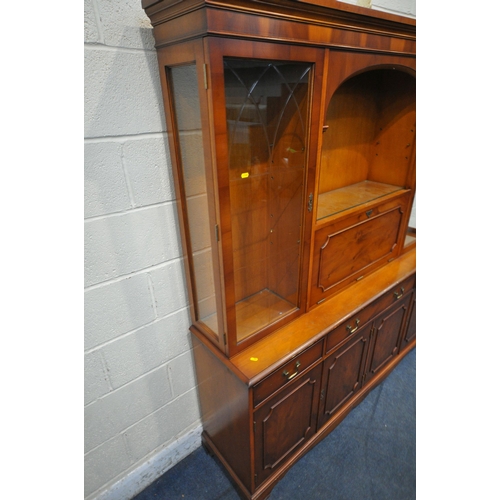 1344 - A LATE 20TH CENTURY MAHOGANY WALL CABINET, with four astragal glazed doors, atop a base with four cu... 