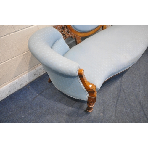 1352 - A LATE VICTORIAN WALNUT SOFA, with an oval backrest, open carving, and patterned blue upholstery, wi... 