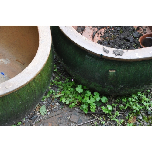 1006 - A PAIR OF GREEN GLAZED PLANTERS, diameter 53cm x height 33cm (condition report: slightly weathered) ... 