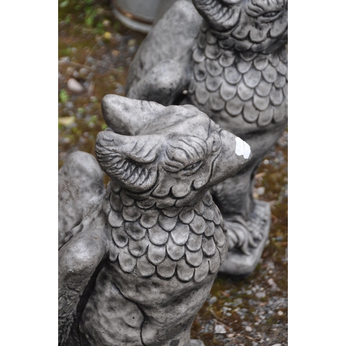 1008 - A PAIR OF COMPOSITE GARDEN FIGURES, of seated griffins, height 55cm (condition report: overall good ... 