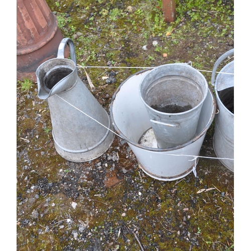 1009 - A SELECTION OF GALVANISED GARDENING ITEMS, to include two watering cans, a pale, and a slim cylindri... 