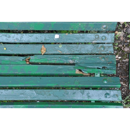 1012 - A GREEN PAINTED GARDEN BENCH, raised on wrought iron legs, length 180cm (condition report: has a cou... 