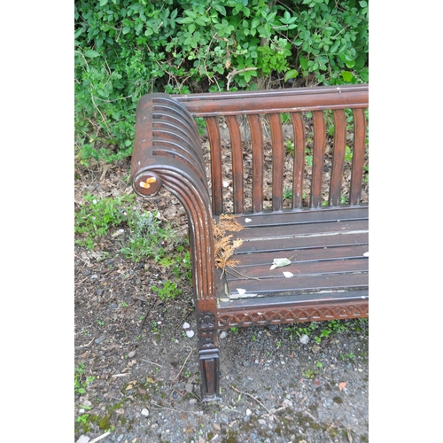 1015 - A STAINED TEAK GARDEN BENCH, with scrolled armrests, raised on square tapered legs, length 157cm (co... 