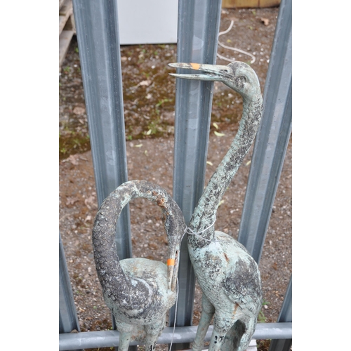 1018 - TWO CAST METAL GARDEN FIGURES, in the form of cranes, one standing upright, the other curling its ne... 