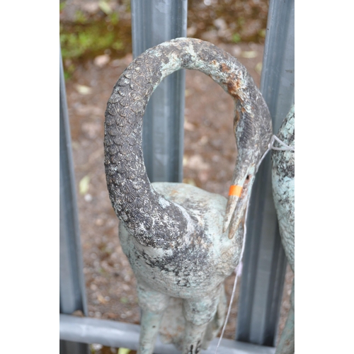 1018 - TWO CAST METAL GARDEN FIGURES, in the form of cranes, one standing upright, the other curling its ne... 