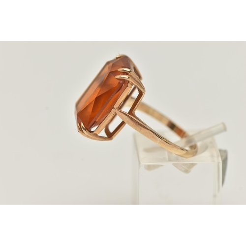 10 - A 9CT GOLD PASTE RING, a large rectangular cut orange paste stone, approximate length 18mm, prong se... 