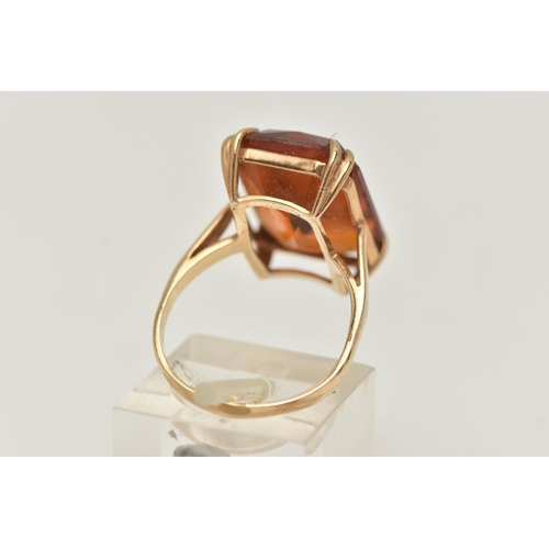 10 - A 9CT GOLD PASTE RING, a large rectangular cut orange paste stone, approximate length 18mm, prong se... 