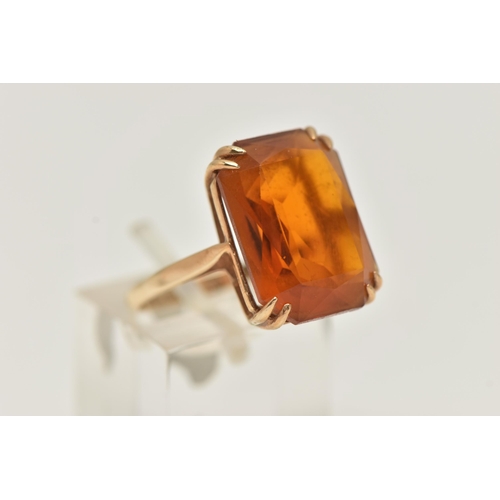 10 - A 9CT GOLD PASTE RING, a large rectangular cut orange paste stone, approximate length 18mm, prong se... 