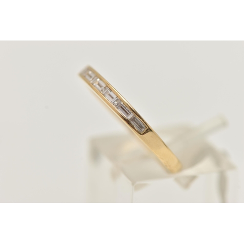 28 - AN 18CT GOLD DIAMOND RING, the yellow gold ring channel set with eight horizontal baguette cut diamo... 