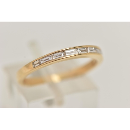 28 - AN 18CT GOLD DIAMOND RING, the yellow gold ring channel set with eight horizontal baguette cut diamo... 