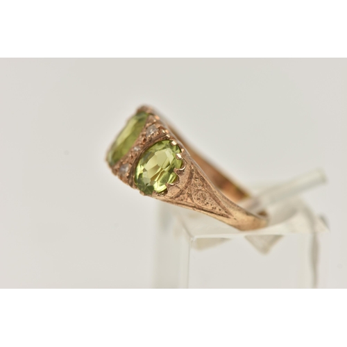 35 - A 9CT GOLD PERIDOT AND DIAMOND RING, designed as three graduated oval shape peridots each interspace... 