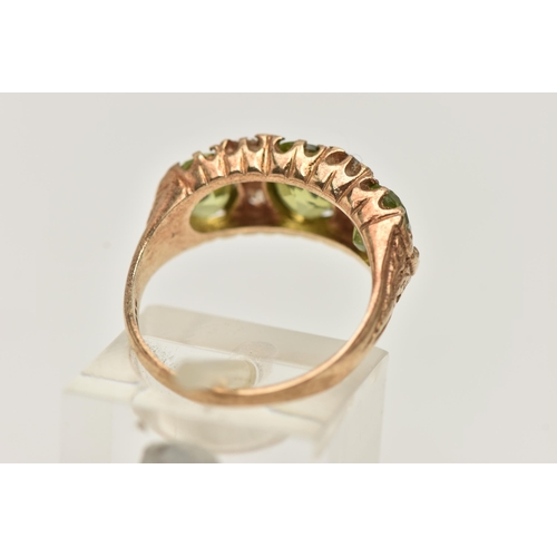 35 - A 9CT GOLD PERIDOT AND DIAMOND RING, designed as three graduated oval shape peridots each interspace... 