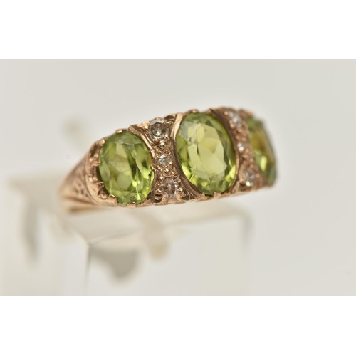 35 - A 9CT GOLD PERIDOT AND DIAMOND RING, designed as three graduated oval shape peridots each interspace... 