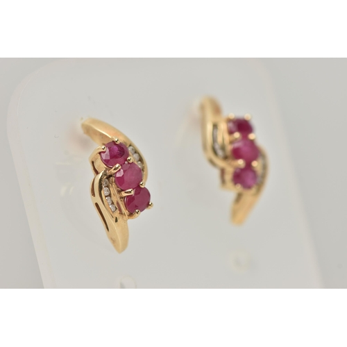 39 - A PAIR OF 9CT GOLD RUBY AND DIAMOND EARRINGS, each designed as a diagonal row of three oval rubies w... 