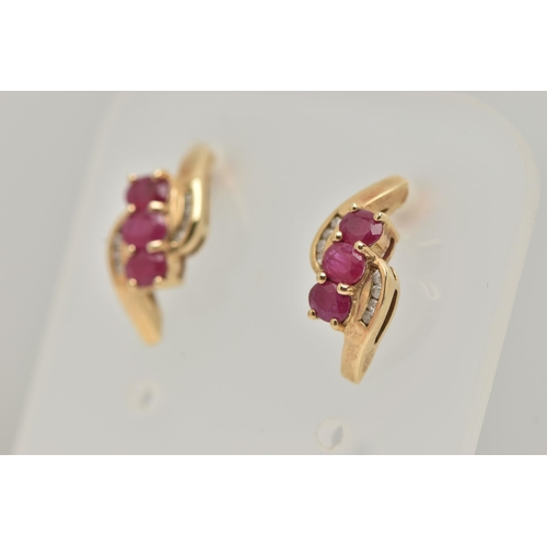 39 - A PAIR OF 9CT GOLD RUBY AND DIAMOND EARRINGS, each designed as a diagonal row of three oval rubies w... 