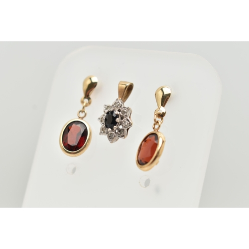 48 - A 9CT GOLD CLUSTER PENDANT AND A PAIR OF YELLOW METAL GARNET DROP EARRINGS, the oval cluster set wit... 