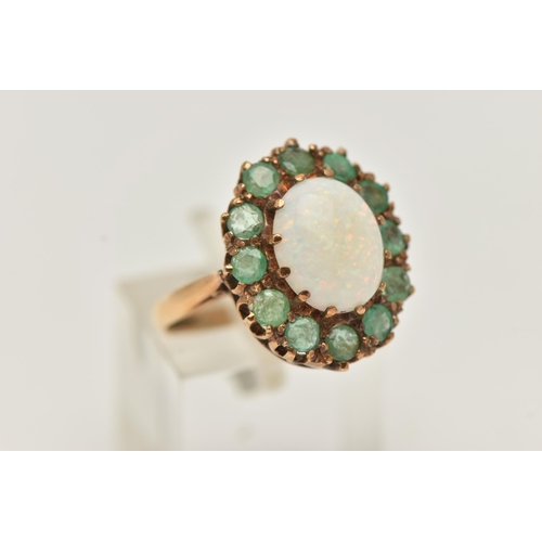 9 - A 9CT GOLD OPAL AND EMERALD RING, a cabochon oval opal, prong set with a surround of circular cut em... 