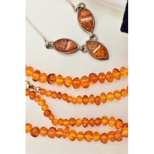 100 - FOUR ITEMS OF JEWELLERY, to include an amber polished pebble necklace, an amber polished bead neckla... 