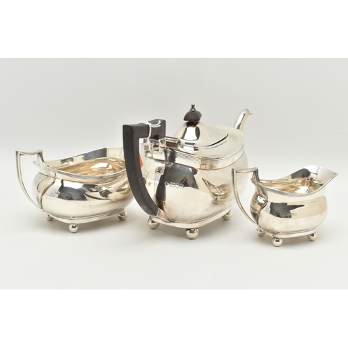 104 - A GEORGE V SILVER THREE PIECE TEA SET, comprising of a teapot, milk jug and double handled sugar bow... 