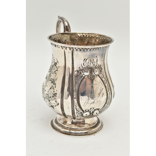 107 - A MID VICTORIAN SILVER CHRISTENING MUG, the bulbous outline embossed with foliate decoration and eng... 