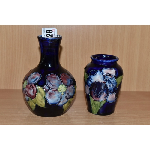 328 - TWO MOORCROFT POTTERY BUD VASES, comprising a Clematis pattern on cobalt blue ground bulbous vase, h... 