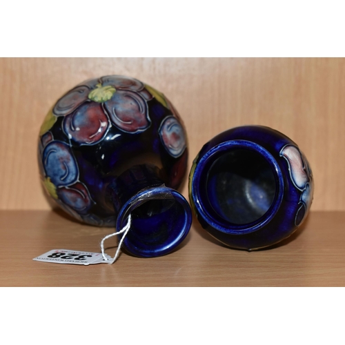 328 - TWO MOORCROFT POTTERY BUD VASES, comprising a Clematis pattern on cobalt blue ground bulbous vase, h... 