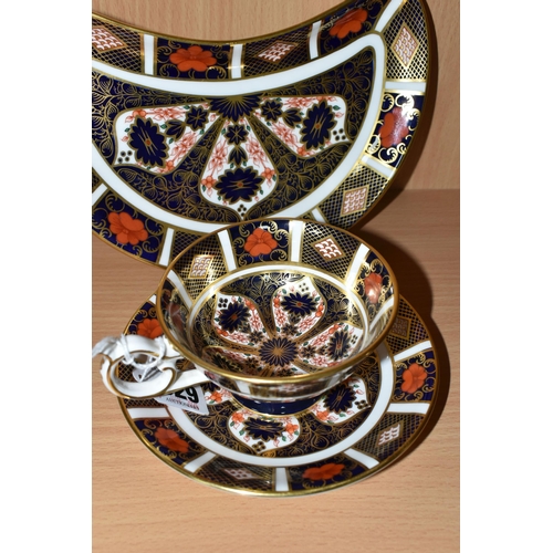 329 - A ROYAL CROWN DERBY IMARI PATTERN 1128 TEA CUP AND SAUCER, together with a crescent shaped plate, co... 