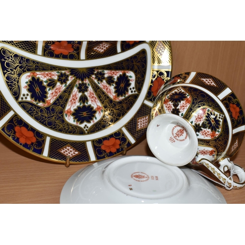 329 - A ROYAL CROWN DERBY IMARI PATTERN 1128 TEA CUP AND SAUCER, together with a crescent shaped plate, co... 