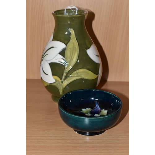 344 - TWO PIECES OF MOORCROFT POTTERY, comprising a Bermuda Lily baluster vase, tube lined with white lily... 