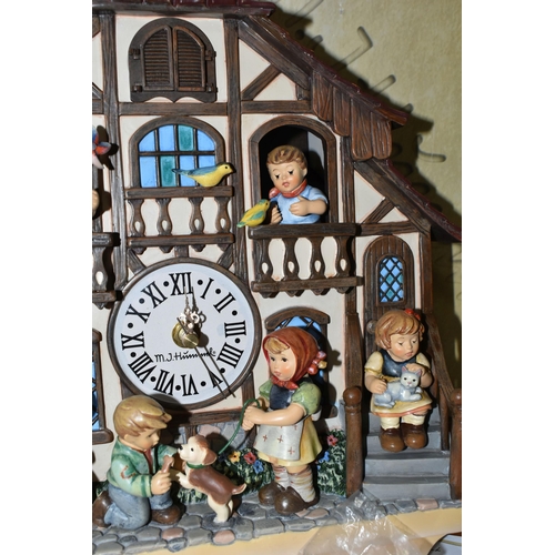 370 - A BOXED HUMMEL CUCKOO CLOCK, by Danbury Mint, depicting seven characters in and around a Bavarian st... 