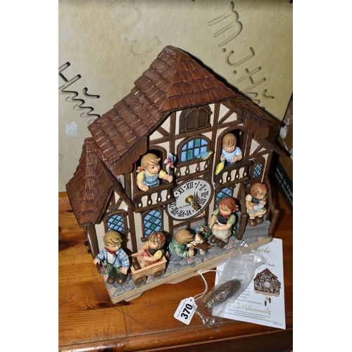 370 - A BOXED HUMMEL CUCKOO CLOCK, by Danbury Mint, depicting seven characters in and around a Bavarian st... 