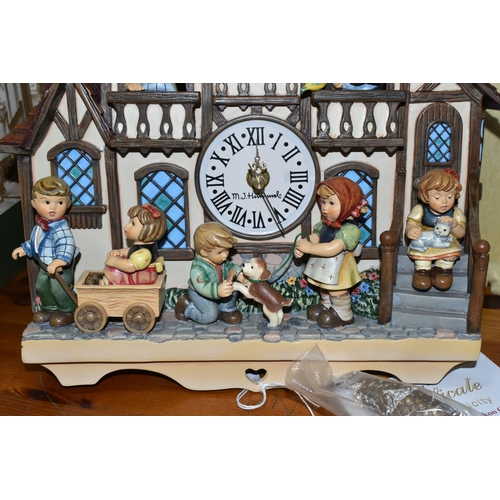 370 - A BOXED HUMMEL CUCKOO CLOCK, by Danbury Mint, depicting seven characters in and around a Bavarian st... 