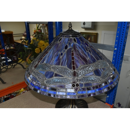 408 - A TIFFANY STYLE LAMP, the metal base is naturalistic style, the leaded glass shade is multi coloured... 