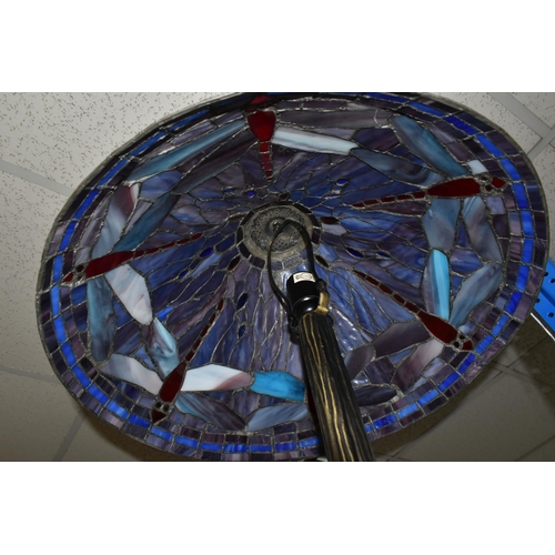 408 - A TIFFANY STYLE LAMP, the metal base is naturalistic style, the leaded glass shade is multi coloured... 