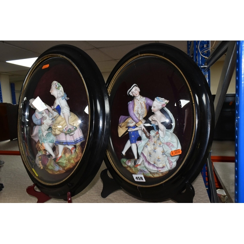 458 - A PAIR OF FRAMED AND GLAZED RELIEF PORCELAIN FIGURE GROUPS, each depicting a courting couple, mounte... 