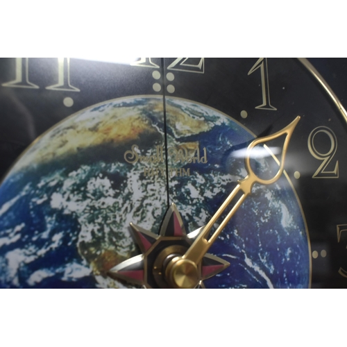 507 - A MUSICAL MOVING 'SMALL WORLD RHYTHM' WALL CLOCK, circus themed, the dial with an image of the Earth... 