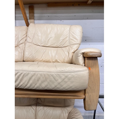 1363 - A LIGHT OAK AND CREAM UPHOLSTERED TWO PIECE LOUNGE SUITE, comprising a three seater settee, width 18... 