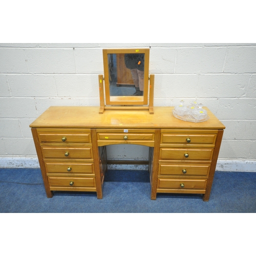 1200 - A GOOD QUALITY SOLID OAK DRESSING TABLE, fitted with nine assorted drawers, width 152cm x depth 49cm... 