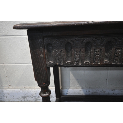 A 19TH CENTURY OAK SIDE TABLE, carved apron, raised on turned legs ...