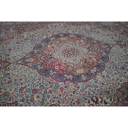 1372 - A PRADO ORIENT MACHINE WOVEN RED PATTERNED RUG, with a repeating pattern, central medallion and mult... 