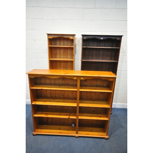 1373 - THREE PINE OPEN BOOKCASES, with an arrangement of shelving, stained bookcase width 86cm x depth 34cm... 