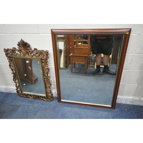 1387 - A FLAMBOYANT GILT FRAMED BEVELLED EDGE WALL MIRROR, 65cm x 102cm, along with a larger mahogany frame... 