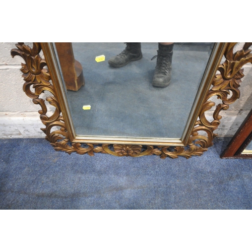 1387 - A FLAMBOYANT GILT FRAMED BEVELLED EDGE WALL MIRROR, 65cm x 102cm, along with a larger mahogany frame... 