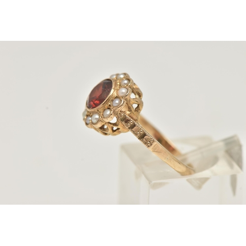 10 - A YELLOW METAL GARNET AND SPLIT PEARL CLUSTER RING, of a circular form set with a central circular c... 