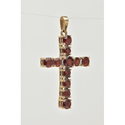 12 - A 9CT GOLD GARNET SET CROSS PENDANT, set with circular cut garnets, fitted with a tapered bail, hall... 