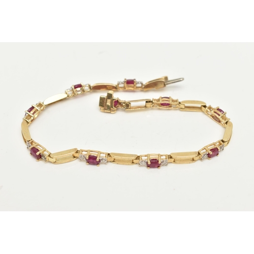 15 - A YELLOW METAL RUBY AND DIAMOND LINE BRACELET, designed as a series of open work links, interspaced ... 