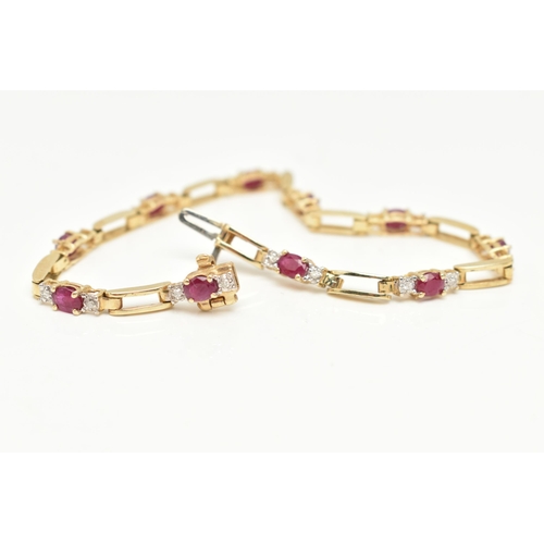 15 - A YELLOW METAL RUBY AND DIAMOND LINE BRACELET, designed as a series of open work links, interspaced ... 