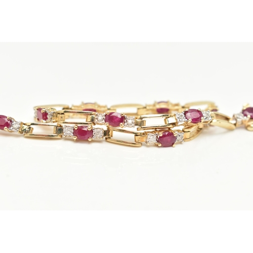 15 - A YELLOW METAL RUBY AND DIAMOND LINE BRACELET, designed as a series of open work links, interspaced ... 