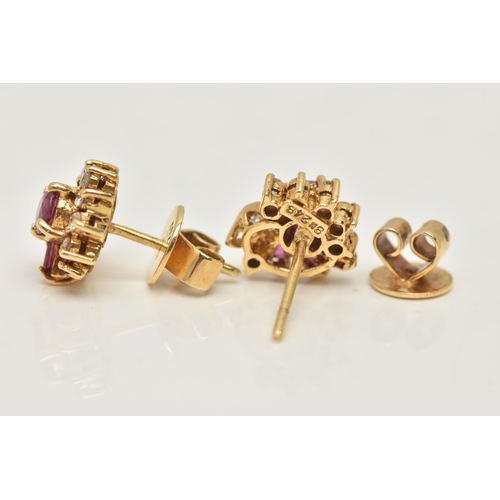 18 - A PAIR OF YELLOW METAL RUBY AND DIAMOND EARRINGS, each designed as a cluster set with a central circ... 