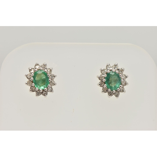 20 - A PAIR OF EMERALD AND DIAMOND EARRINGS AND A PENDANT, each earring designed as an oval cluster, set ... 